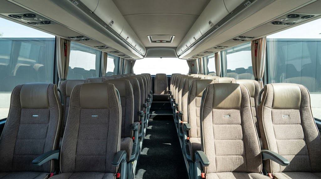 Luxury Singapore bus charter interior with comfortable seats and large windows for scenic travel.