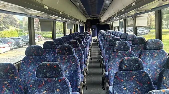 Modern Singapore bus interior with comfortable seats and large windows.